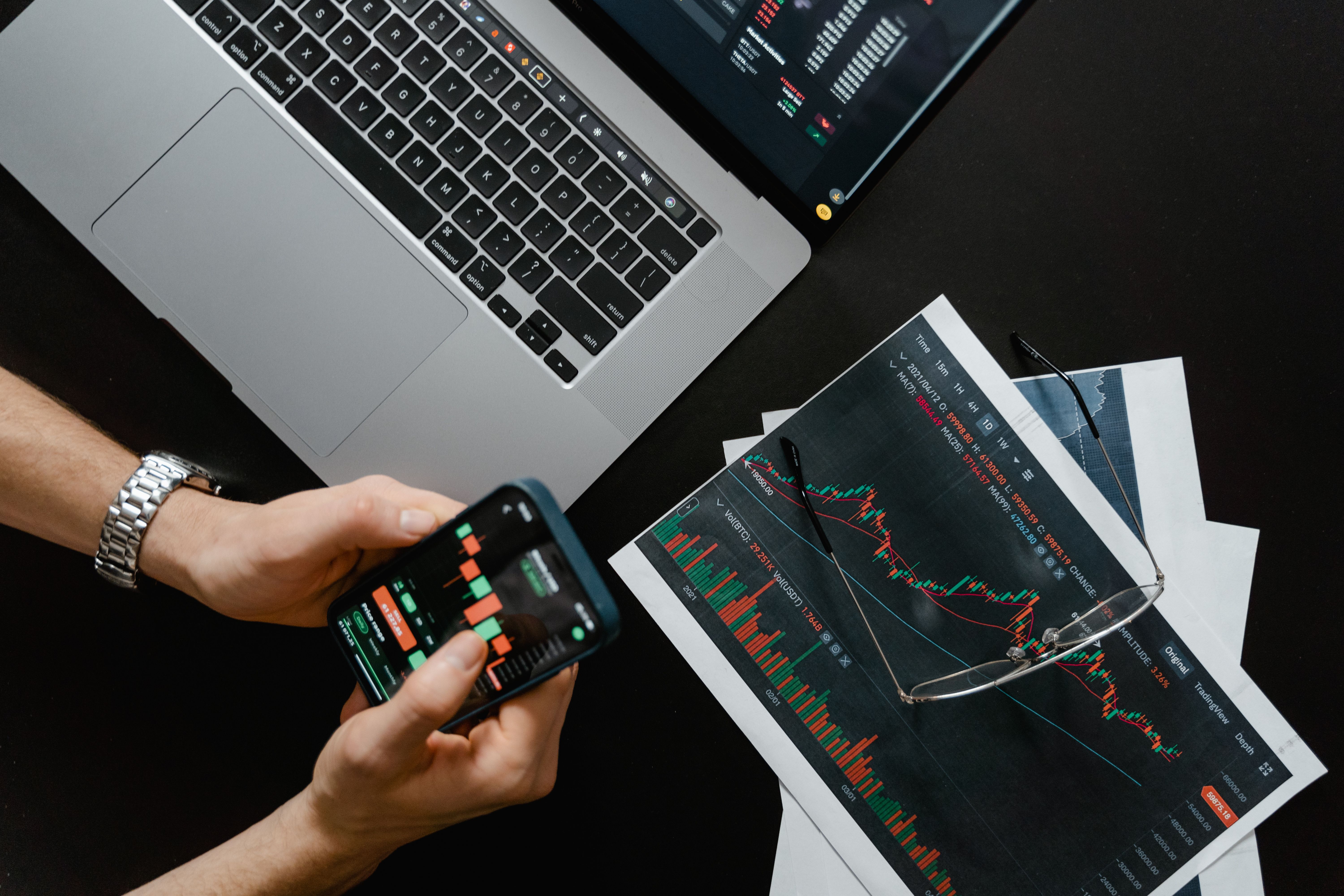 Trader analysing multiple market screens